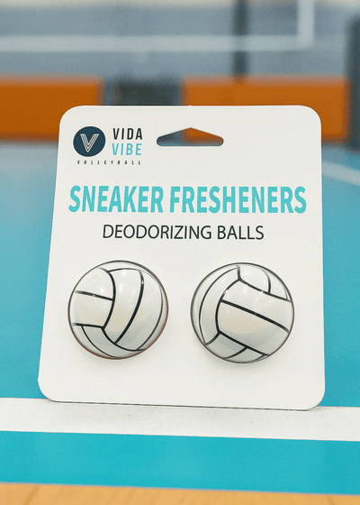 Vida Vibe sneaker fresheners with volleyball design on a blue background